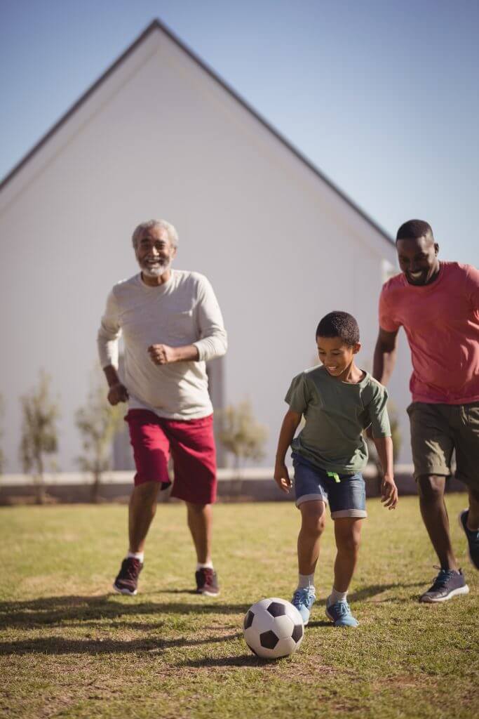 Boy playing football with his father and grandson shows the need for salt electrolytes featured next