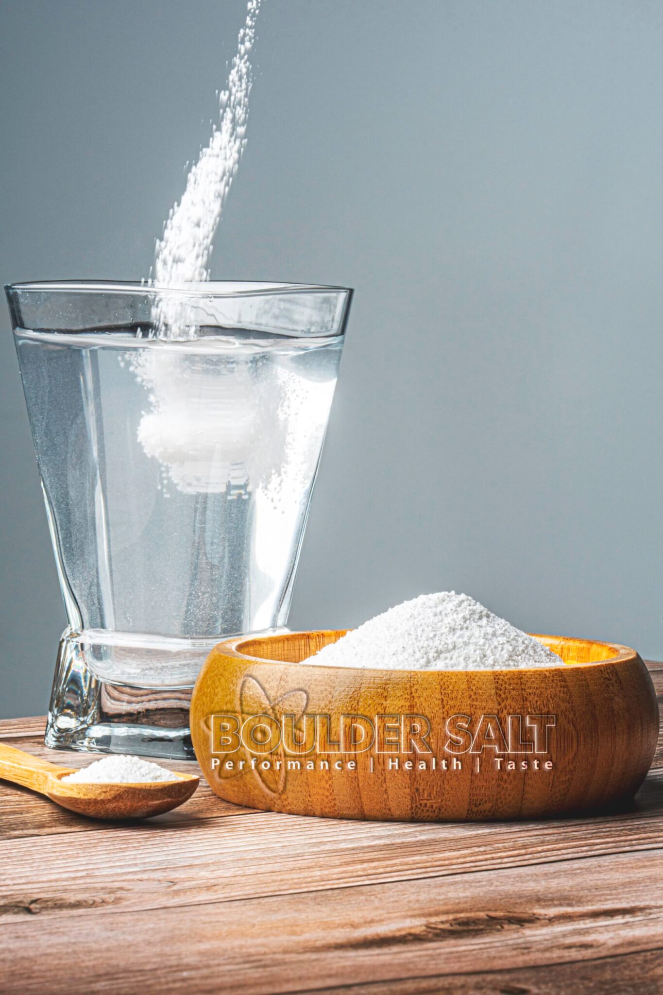 Boulder Salt unflavored electrolyte powder next to a glass of water