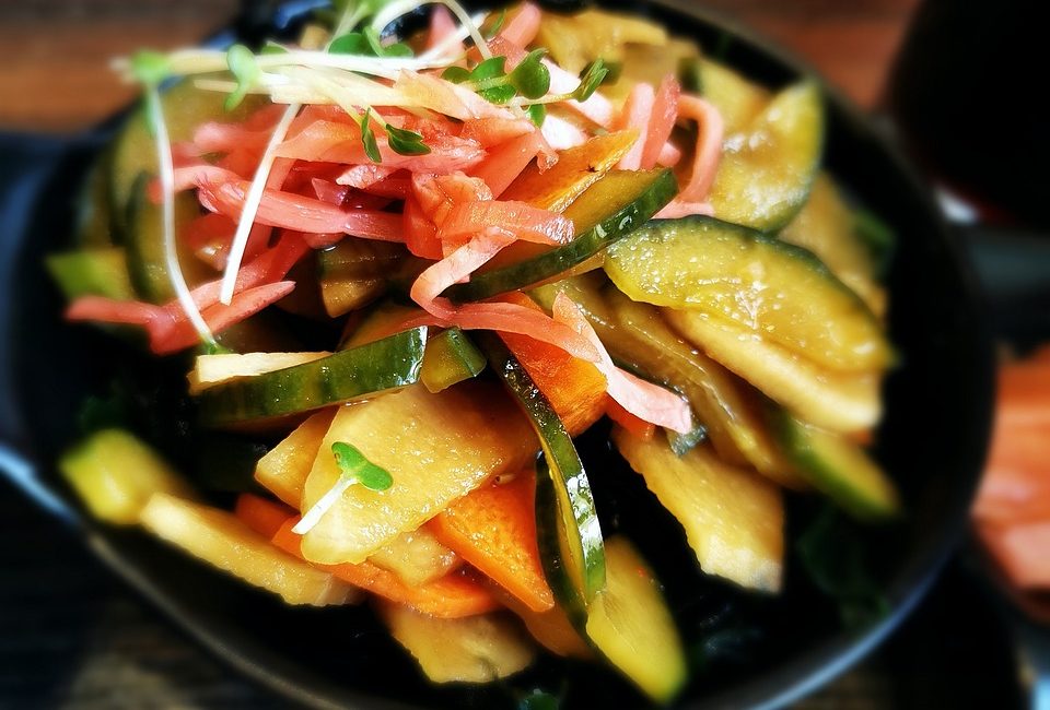 A colorful bowl of pickled cucumbers and carrots, demonstrating how Boulder Salt enhances the nutritional value and flavor of fresh, healthy vegetables
